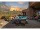 Beautiful backyard with a pool, dining area, and mountain views at 35345 N Canyon Creek Ct, Carefree, AZ 85377