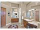 Double sink bathroom with wood cabinets, tile floors, and ample mirror space at 35345 N Canyon Creek Ct, Carefree, AZ 85377