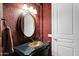 Stylish powder room with gold fixtures, decorative wallpaper, and designer vanity at 35345 N Canyon Creek Ct, Carefree, AZ 85377