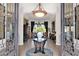 Elegant foyer with an eye-catching light fixture and views into the dining room at 35345 N Canyon Creek Ct, Carefree, AZ 85377