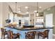 Kitchen with bar seating, white cabinets, and pendant lighting at 35345 N Canyon Creek Ct, Carefree, AZ 85377