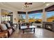 Bright living room with a fireplace and picturesque outdoor views at 35345 N Canyon Creek Ct, Carefree, AZ 85377