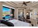 Comfortable main bedroom with a trey ceiling, ceiling fan, and an exterior view of the pool at 35345 N Canyon Creek Ct, Carefree, AZ 85377