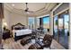 Bright main bedroom with a trey ceiling, ceiling fan, and glass doors leading to the backyard at 35345 N Canyon Creek Ct, Carefree, AZ 85377