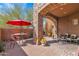 Outdoor living space with stone columns and a red umbrella is perfect for relaxing at 35345 N Canyon Creek Ct, Carefree, AZ 85377