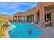 Inviting pool with a water feature and covered seating area offers a resort-like backyard experience at 35345 N Canyon Creek Ct, Carefree, AZ 85377