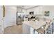 Modern kitchen with stainless steel appliances, white cabinetry, and a center island with seating at 36620 W Mondragone Ln, Maricopa, AZ 85138