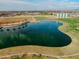 Beautiful aerial view of a large lake and green space with silos in the distance on a bright, sunny day at 3744 E Sierra Madre Ave, Gilbert, AZ 85296