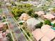 Aerial shot of a residential property with an ornate tile roof, lawn, and mature trees at 3744 E Sierra Madre Ave, Gilbert, AZ 85296