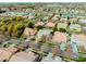 A suburban neighborhood, showcasing houses with tile roofs, verdant lawns, and backyard pools at 3744 E Sierra Madre Ave, Gilbert, AZ 85296