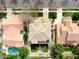 An aerial view captures the home, showcasing its tiled roof, pristine landscaping, and backyard pool at 3744 E Sierra Madre Ave, Gilbert, AZ 85296