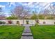 Lush backyard featuring manicured lawn, a pathway, and flowering plants, perfect for outdoor enjoyment at 3744 E Sierra Madre Ave, Gilbert, AZ 85296