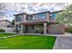 Beautifully landscaped backyard showcases lush grass, a stone path, and an elegant two-story home at 3744 E Sierra Madre Ave, Gilbert, AZ 85296