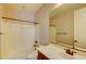 Bright bathroom featuring a tub shower combo, light countertops, and a modern vanity with dark wood cabinets at 3744 E Sierra Madre Ave, Gilbert, AZ 85296