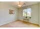 Minimalist bedroom featuring neutral walls, carpeted floors, and a large window offering great natural light at 3744 E Sierra Madre Ave, Gilbert, AZ 85296