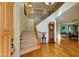 Grand foyer with hardwood floors, staircase with iron railings, and a grandfather clock at 3744 E Sierra Madre Ave, Gilbert, AZ 85296