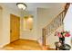 Elegant foyer with hardwood floors, staircase with iron railings and a decorative niche at 3744 E Sierra Madre Ave, Gilbert, AZ 85296