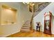 Grand foyer with hardwood floors, staircase with iron railings and a decorative niche with decor at 3744 E Sierra Madre Ave, Gilbert, AZ 85296