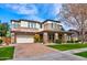 Inviting two-story home with stone accents, manicured lawn, brick driveway, and a welcoming facade at 3744 E Sierra Madre Ave, Gilbert, AZ 85296