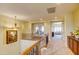 Bright hallway featuring wood railing, neutral tones, and a view into another living space at 3744 E Sierra Madre Ave, Gilbert, AZ 85296