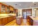 Open kitchen area featuring granite countertops, wood cabinets, stainless steel appliances, and a large island at 3744 E Sierra Madre Ave, Gilbert, AZ 85296