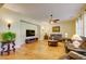 Open concept living room with hardwood floors, a ceiling fan, and a large flat-screen TV at 3744 E Sierra Madre Ave, Gilbert, AZ 85296