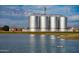 View of four silos by a green lake with ducks swimming nearby and a bench for relaxing at 3744 E Sierra Madre Ave, Gilbert, AZ 85296