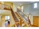 Elegant staircase with carpeted steps, wooden banister, and decorative wrought iron balusters at 3744 E Sierra Madre Ave, Gilbert, AZ 85296