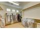 Organized walk-in closet with ample storage and clothing racks at 3744 E Sierra Madre Ave, Gilbert, AZ 85296