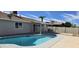 Refreshing pool with a grey fence and white trim offers a private backyard oasis at 4038 E Burgess Ln, Phoenix, AZ 85042