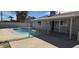 Backyard view of sparkling pool and covered patio, perfect for outdoor relaxation at 4038 E Burgess Ln, Phoenix, AZ 85042