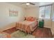 Bedroom with a colorful bedspread, hardwood floors, and plenty of natural light at 4120 N 78Th St # 217, Scottsdale, AZ 85251