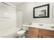 Bright bathroom featuring a shower-tub combo, toilet, and vanity sink with modern fixtures at 4186 E Jasper Dr, Gilbert, AZ 85296