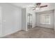 Cozy bedroom featuring neutral carpeting, ceiling fan, and closet with mirrored sliding doors at 4186 E Jasper Dr, Gilbert, AZ 85296