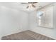 Bright bedroom with neutral carpet, ceiling fan and window at 4186 E Jasper Dr, Gilbert, AZ 85296