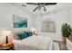 Relaxing bedroom featuring a ceiling fan, plush bedding, and ample natural light at 4186 E Jasper Dr, Gilbert, AZ 85296