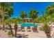 Relaxing community pool area with lounge chairs under palm trees at 4186 E Jasper Dr, Gilbert, AZ 85296