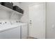 Laundry room featuring a washing machine, dryer, and shelves at 4186 E Jasper Dr, Gilbert, AZ 85296