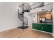 Open-concept living area with spiral staircase and modern kitchen in the background at 4186 E Jasper Dr, Gilbert, AZ 85296