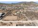 Aerial view of desert property featuring multiple structures and riding arena at 43228 N 14Th St, New River, AZ 85087