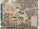 Overhead view of a desert property with multiple structures and land features at 43228 N 14Th St, New River, AZ 85087