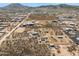 Aerial view showcasing a rural property with various buildings and scenic mountain backdrop at 43228 N 14Th St, New River, AZ 85087