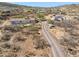 Aerial view of a desert home with a long driveway and surrounded by native vegetation at 43228 N 14Th St, New River, AZ 85087