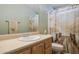 Bright bathroom with a neutral color scheme, ample counter space, and decorative shower curtain at 43228 N 14Th St, New River, AZ 85087