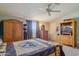 Bedroom with a wooden dresser, closet, and a television at 43228 N 14Th St, New River, AZ 85087