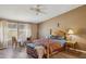 Cozy bedroom featuring a wooden bed frame, wood floors, and natural light at 43228 N 14Th St, New River, AZ 85087