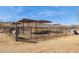 Horse facilities with covered stalls and fenced area on sunny day at 43228 N 14Th St, New River, AZ 85087