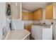 Functional laundry room with washer, dryer, storage cabinets, and ample counter space at 43228 N 14Th St, New River, AZ 85087