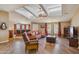 Open-concept living room with a bar, skylights, and hardwood flooring at 43228 N 14Th St, New River, AZ 85087