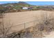 Outdoor riding arena featuring metal rail fencing and desert vegetation at 43228 N 14Th St, New River, AZ 85087